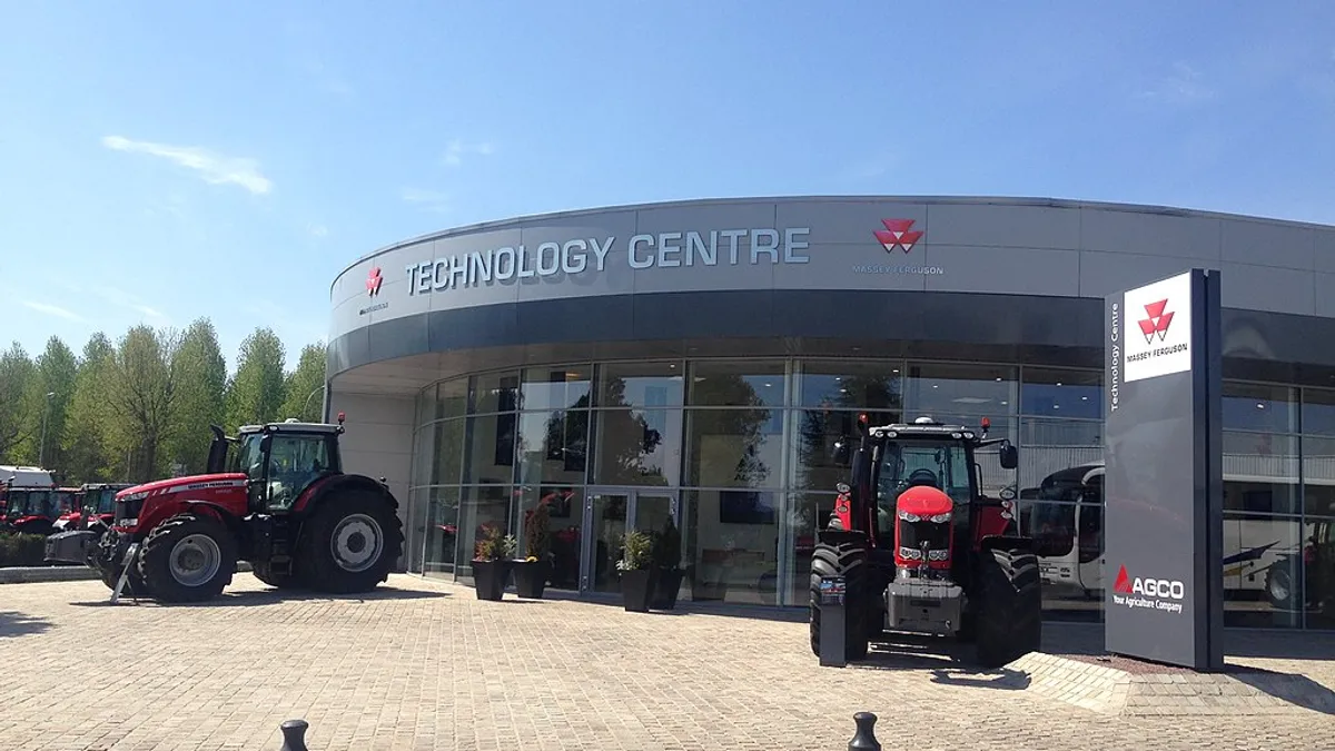 Agco tractors are seen in front of a technology center