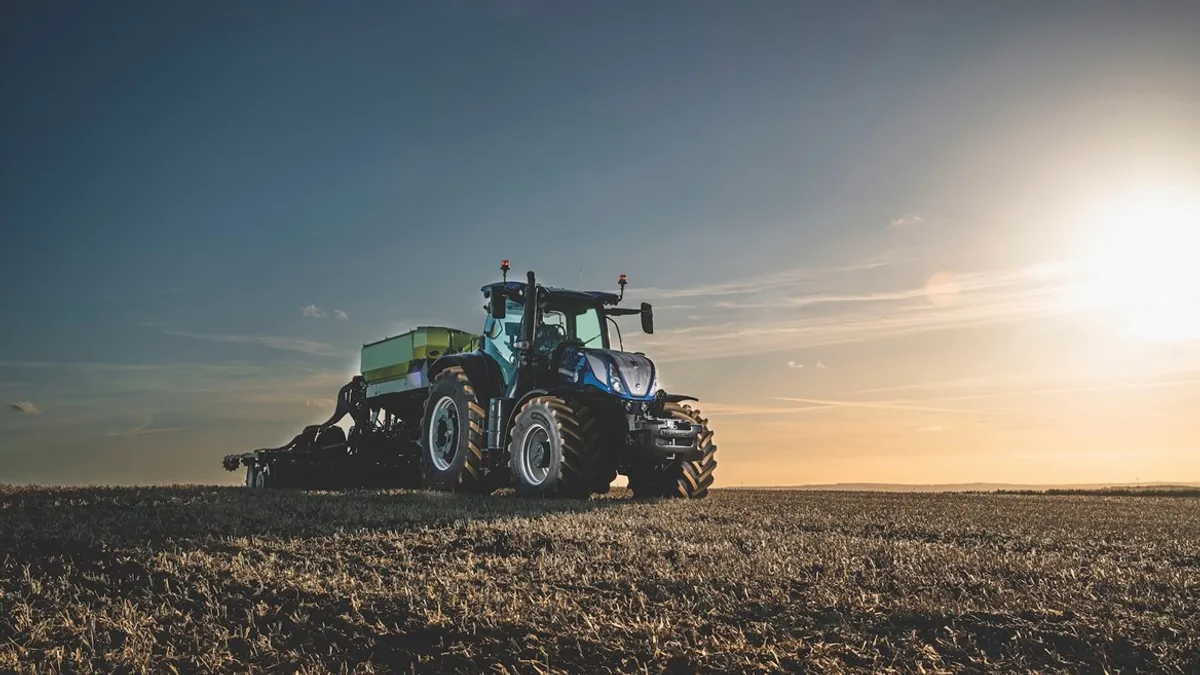 A blue CNH tractor is seen on a farm