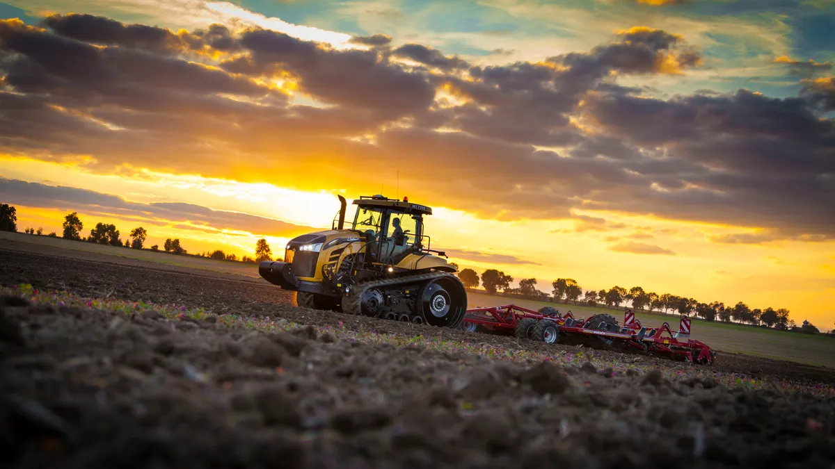 A farmer uses Agco equipment and technology to manage the fields.