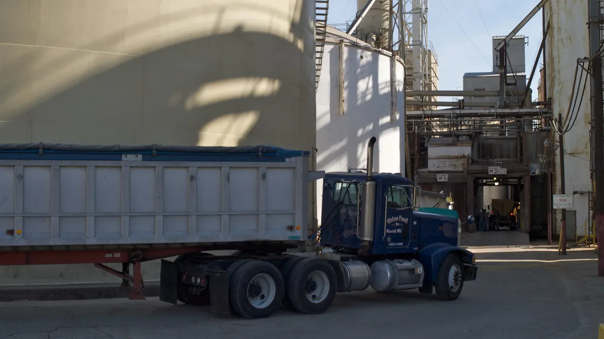 A truck is seen pulling into a grain facility