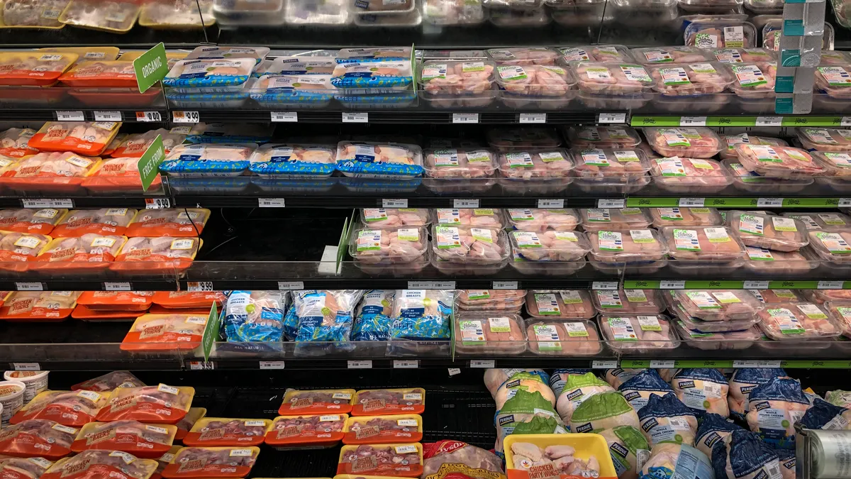 A view of the chicken and meat section at a grocery store.