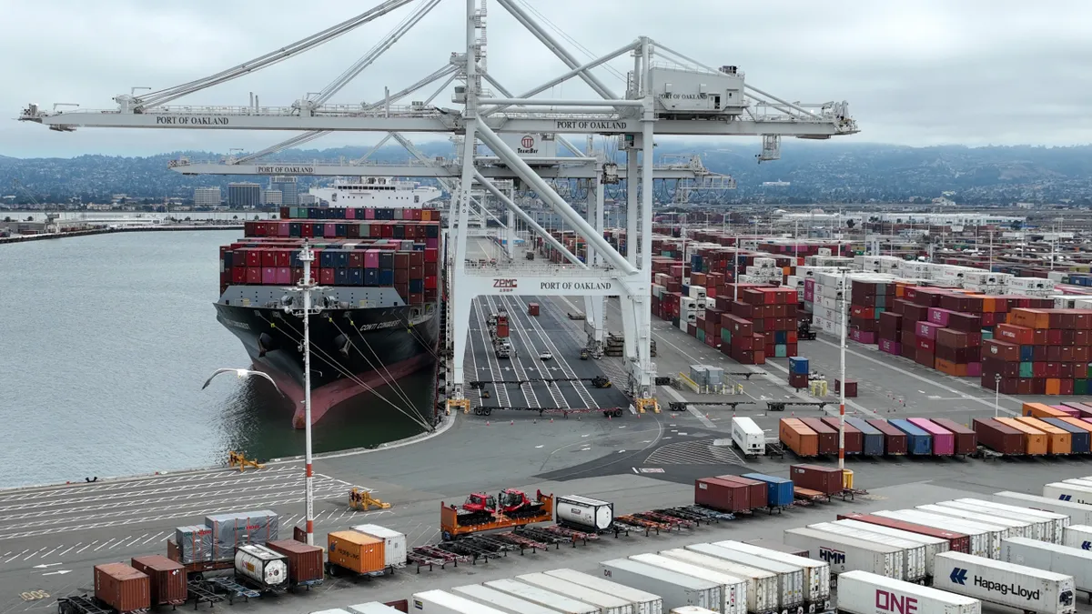 In an aerial view, a container ship sits idle at the Port of Oakland on July 21, 2022 in Oakland, California.