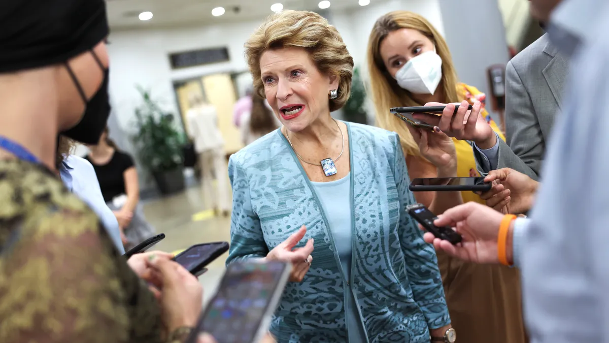 Sen. Debbie Stabenow speaks to a group of reporters.