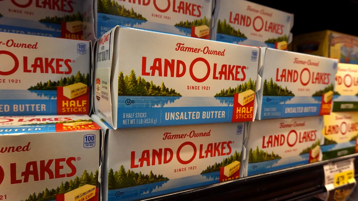 Land O'Lakes butter is displayed on a refrigerated shelf.