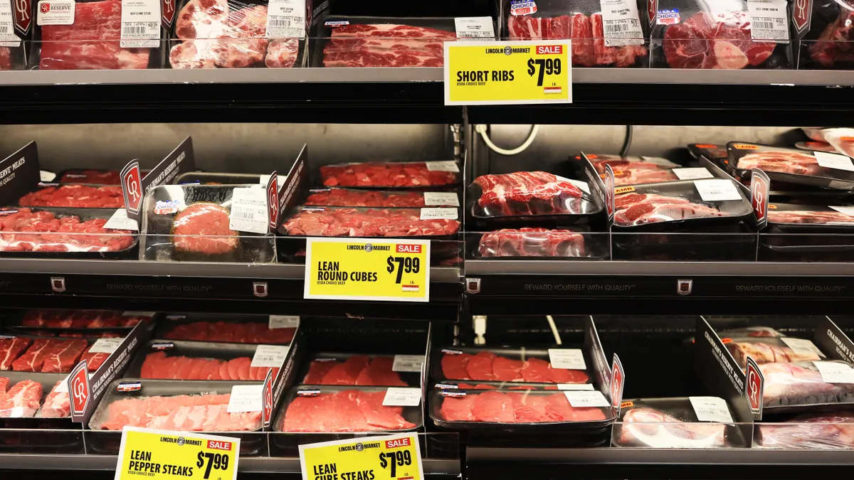 Various cuts of packaged beef are seen in a grocery store