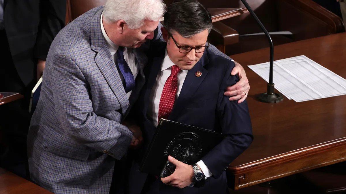 Two men hug on the floor of the U.S. Capitol