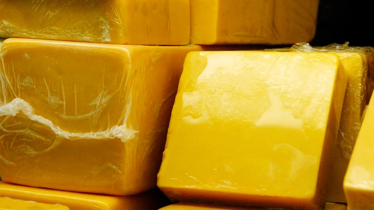 Blocks of cheddar cheese on display.