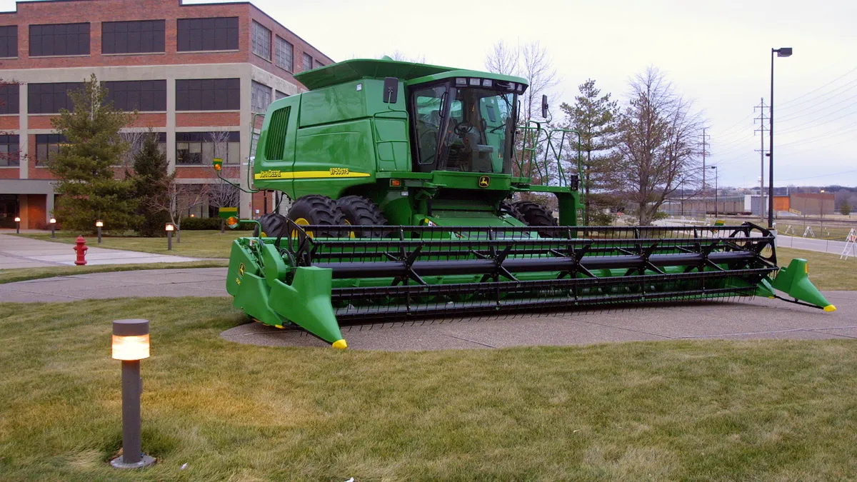 A combine is displayed outside of Deere's Harvester Works factory where it is manufactured in East Moline, Illinois.