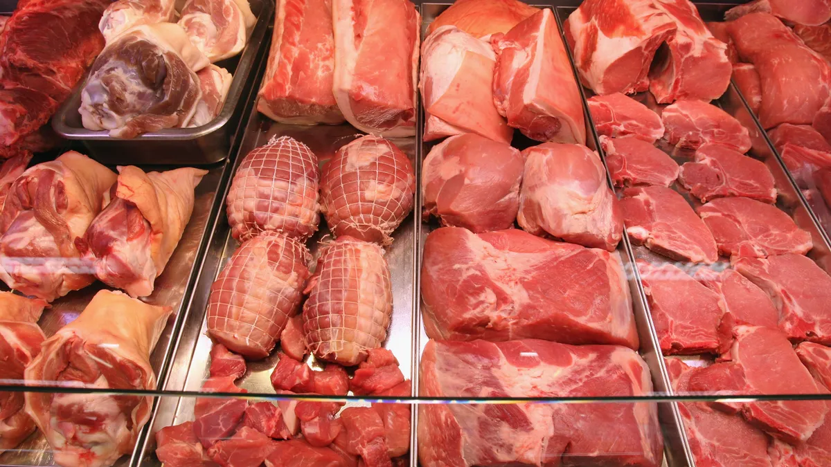 Variety of butchered meat in a display counter