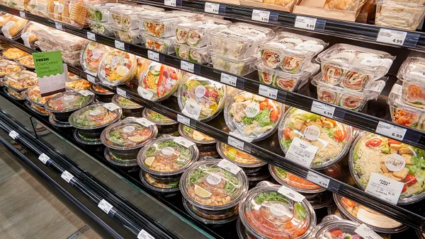 Prepared foods offering, including grain bowls and deli sandwiches packed in plastic to-go containers