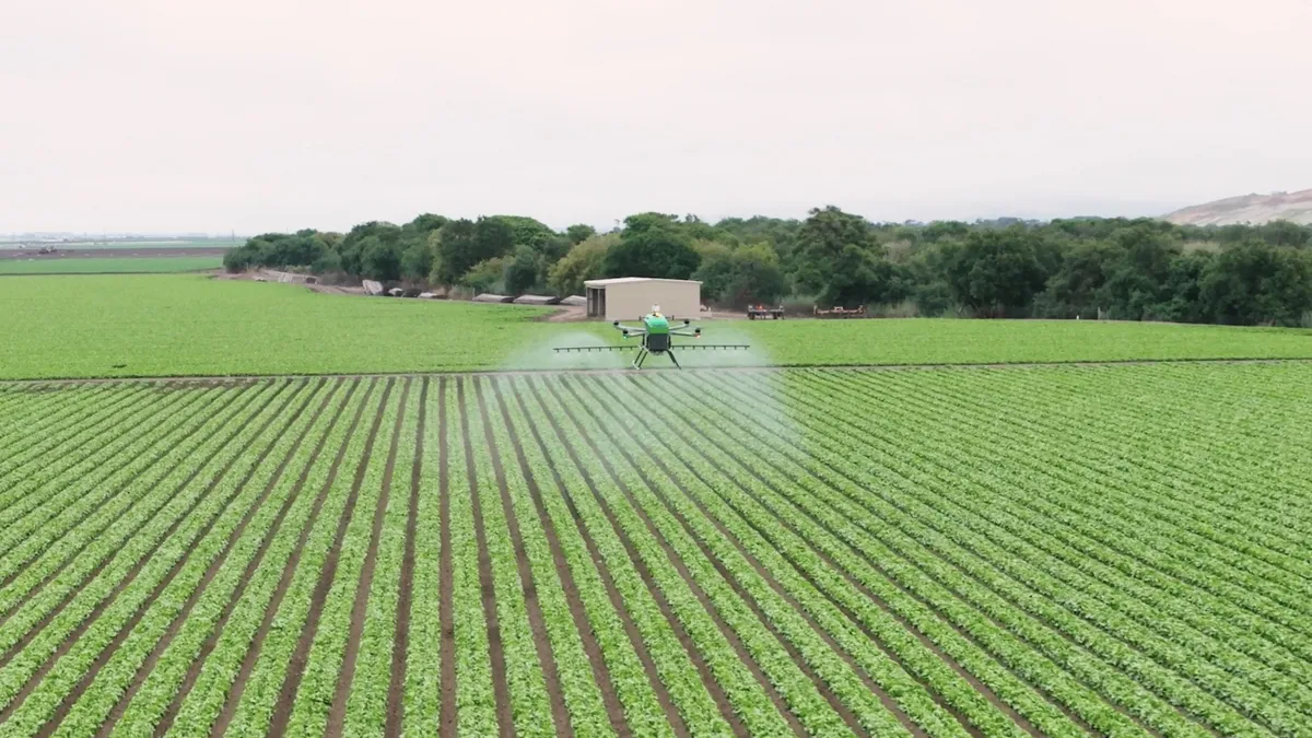 Guardian Agriculture's SC1 eVTOL sprays crops in California.